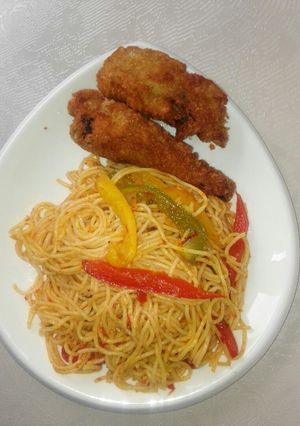 A picture of Vegetabled, Jollof spaghetti and crispy fried chicken.