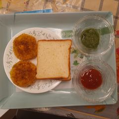 A picture of Grilled veg corn cutlet with bread butter.