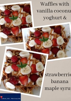 A picture of Waffles with vanilla coconut yoghurt & strawberries banana maple.