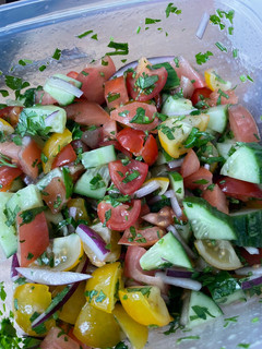 A picture of Tomato, cucumber and avocado salad.