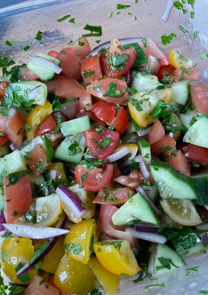 A picture of Tomato, cucumber and avocado salad.