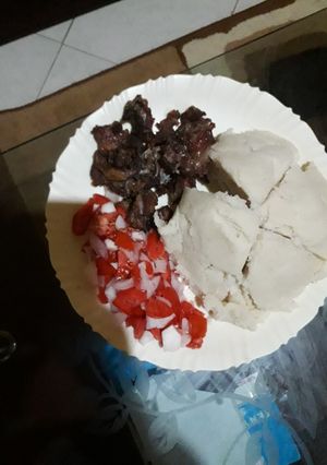 A picture of Ugali,goat meat fry and kachumbari.