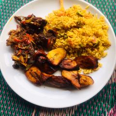 A picture of Jollof rice, fried plantain & pepper meat🥩.