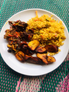 A picture of Jollof rice, fried plantain & pepper meat🥩.