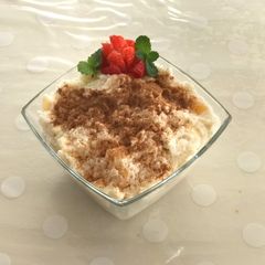 A picture of Poha curd with honey and fruits.