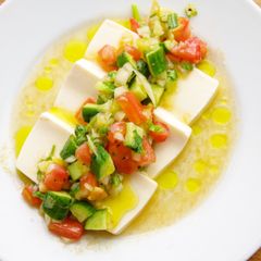 A picture of Tofu with summer veggies &  olive oil ✨🍅.