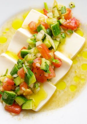 A picture of Tofu with summer veggies &  olive oil ✨🍅.