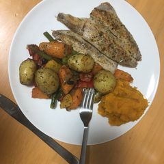 A picture of Grilled fish and baked vegetables.