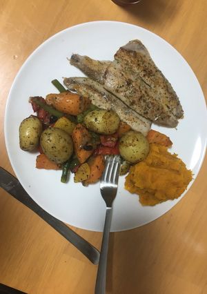A picture of Grilled fish and baked vegetables.
