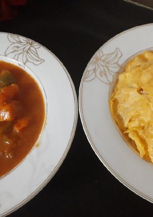 A picture of Chicken jalfrezi with vegetable fried rice.