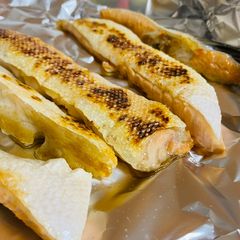 A picture of “Grilled” Salmon belly on stove.
