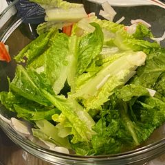 A picture of Romaine lettuce salad with crab stick and homemade dressing.