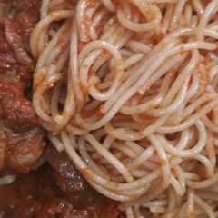 A picture of Jollof spaghetti with chicken.