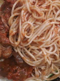 A picture of Jollof spaghetti with chicken.