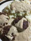 Gravy smothered hamburgers and mashed potatoes