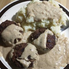 Gravy smothered hamburgers and mashed potatoes A picture of Gravy smothered hamburgers and mashed potatoes.