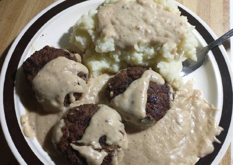 Gravy smothered hamburgers and mashed potatoes