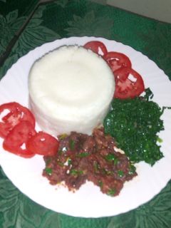 A picture of Wet fry beef, Kales and ugali.