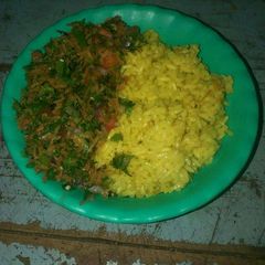 A picture of Turmeric rice and kachumbari.
