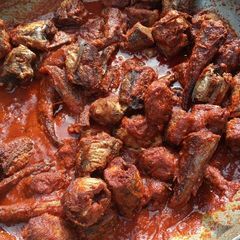 A picture of Fresh tomato and fish stew.