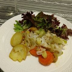 A picture of Cod Fish with vegetables.