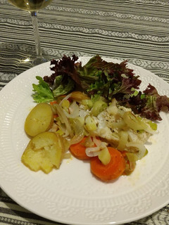 A picture of Cod Fish with vegetables.