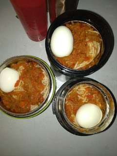 A picture of Spaghetti,boiled egg and tomato sauce.