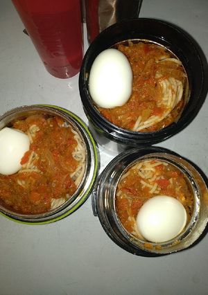 A picture of Spaghetti,boiled egg and tomato sauce.