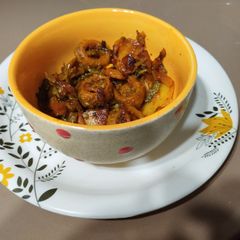 Punjabi bitter gourd rounds in tomato gravy A picture of Punjabi bitter gourd rounds in tomato gravy.