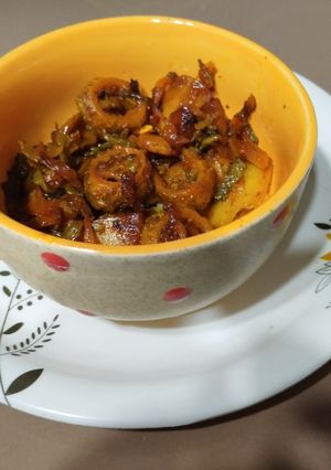 A picture of Punjabi bitter gourd rounds in tomato gravy.