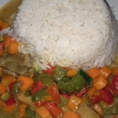 A picture of Rice and chicken curry sauce with coconut milk.