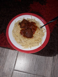 A picture of Spaghetti with goat meat tomato sauce.