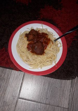 A picture of Spaghetti with goat meat tomato sauce.