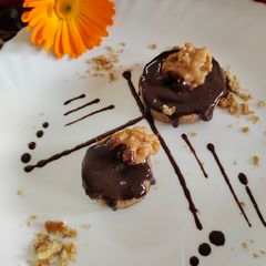 A picture of Walnuts poppy seeds halwa with chocolate ganache n topped with jaggery coated walnuts.