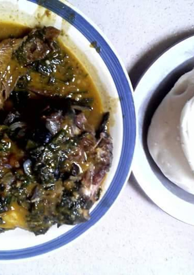 A picture of Bitterleaf soup with snail and akpu.