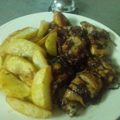 A picture of Roasted potatoes and fried pork.