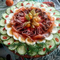 A picture of 2 layers of Swedish smörgåstårta (Swedish sandwich cake).