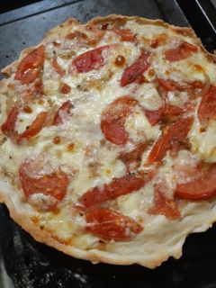 Una foto de Tarta de cebolla, tomate, queso y salsa blanca