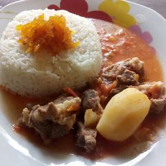 A picture of Rice and mutton soup curry with mango pickle.