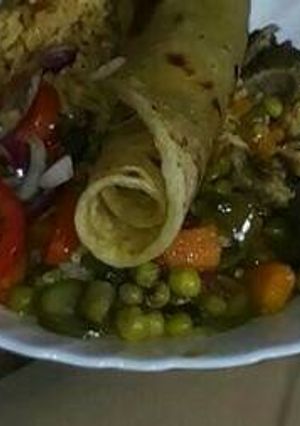 A picture of Rice and green peas and beef stew with kachumbari.