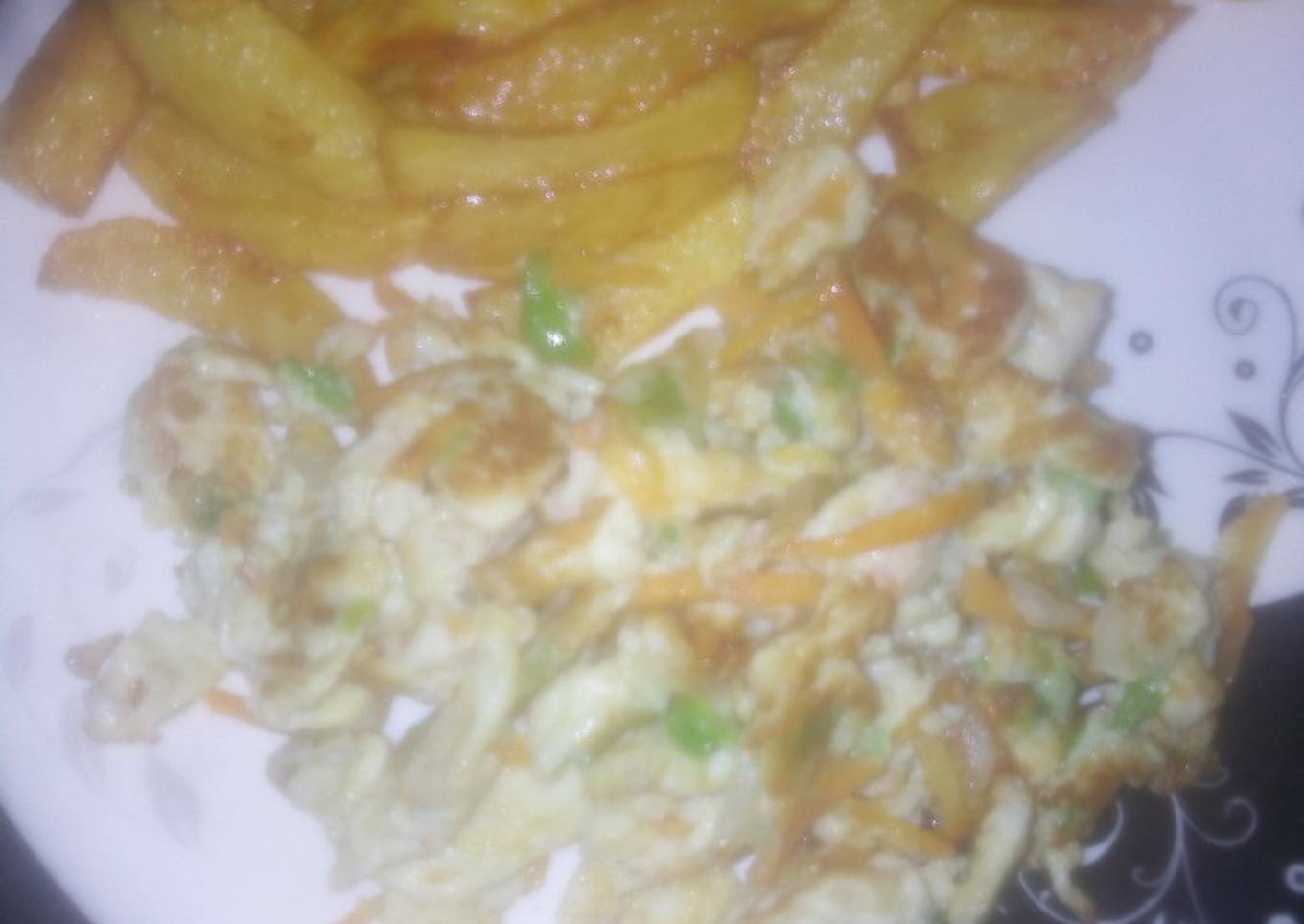 Homemade French fries and vegetables scrambled egg