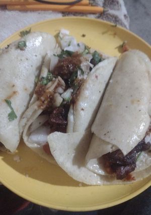 A picture of Chicharrón Tacos #2 with Fried Adobo Beans.