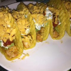 A picture of Shrimp tacos with home-made guacamole and fresh cream sauce.