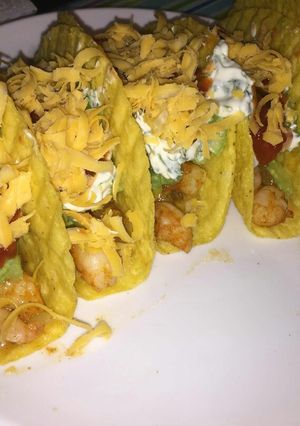 A picture of Shrimp tacos with home-made guacamole and fresh cream sauce.