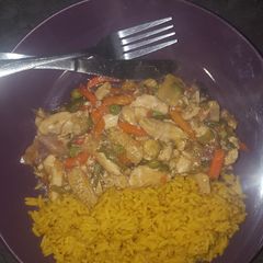 A picture of Chicken Stir-Fry served with spiced rice.