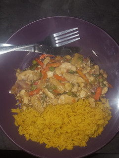 A picture of Chicken Stir-Fry served with spiced rice.