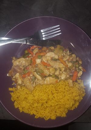 A picture of Chicken Stir-Fry served with spiced rice.