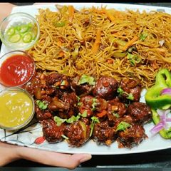 A picture of Veg Noddles with dry manchurian balls.