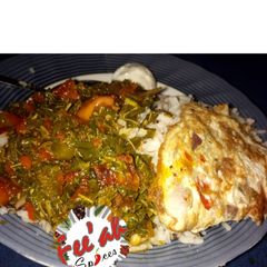 A picture of White rice wv vegetable sauce n fried n boiled egg.