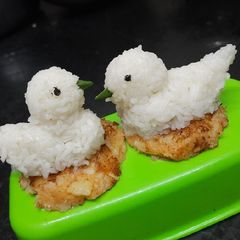 A picture of Boil rice with potato cutlet.